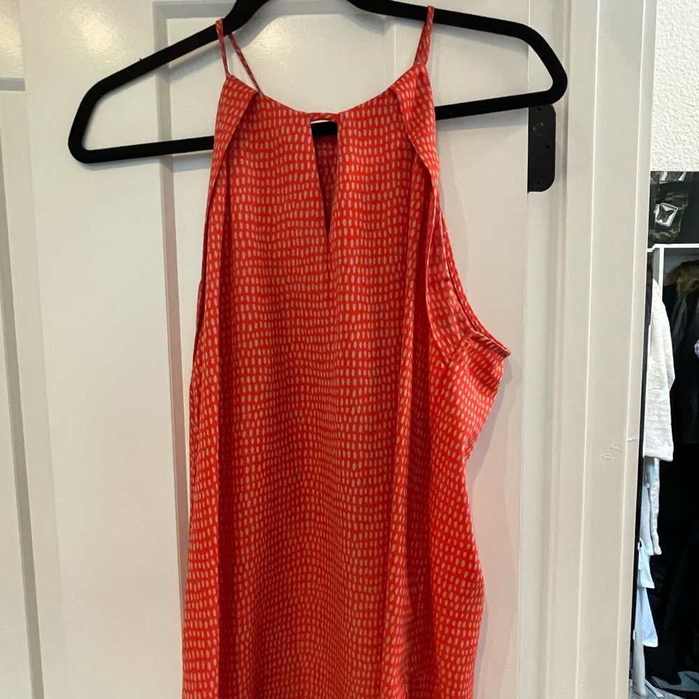 Cute orange tank blouse. Longer in the back.